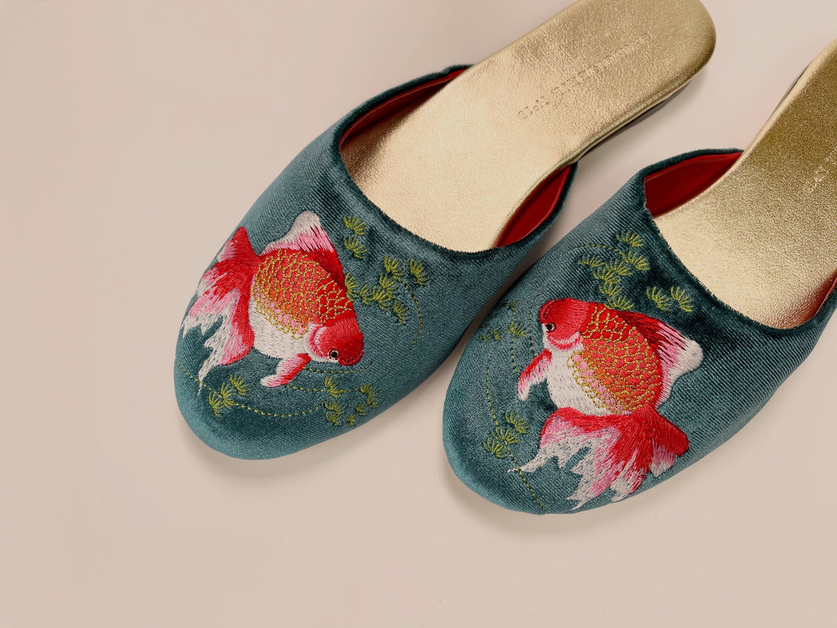 Teal velvet mule slippers with two goldfish designs, beige footbeds and red lining