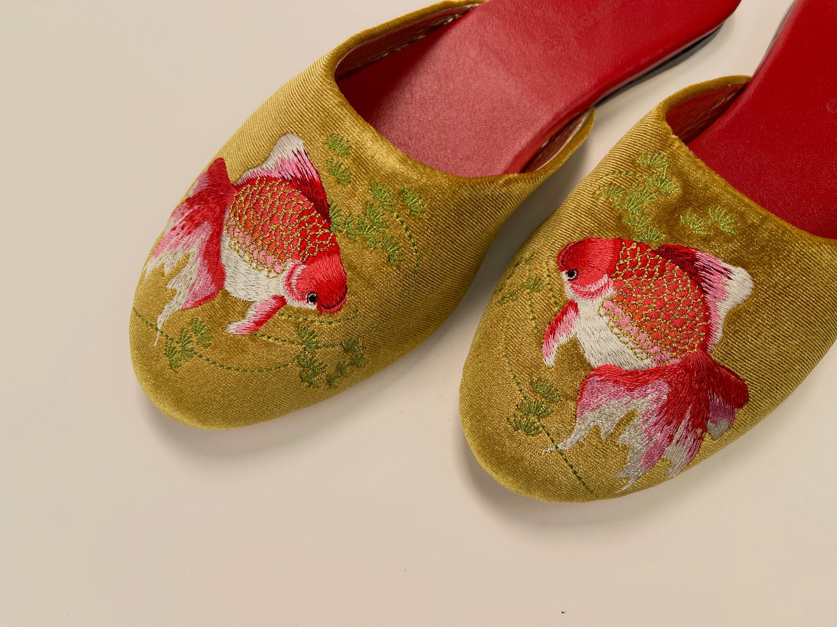 Gold velvet mule slippers featuring red and white goldfish embroidery, red lining inside