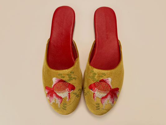 Pair of gold velvet mule slippers with red and white goldfish embroidery and red lining