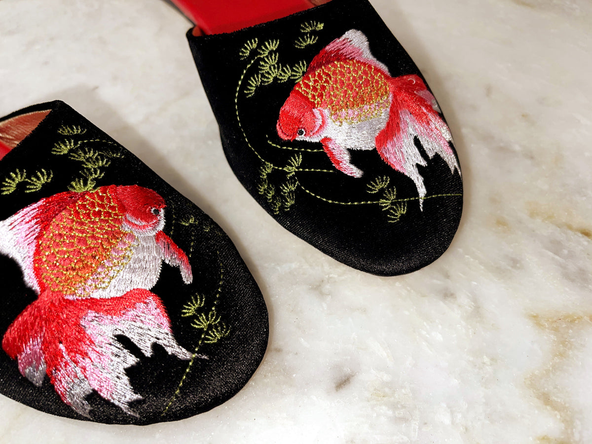 Goldfish-embroidered black velvet mule toe detail with red edging