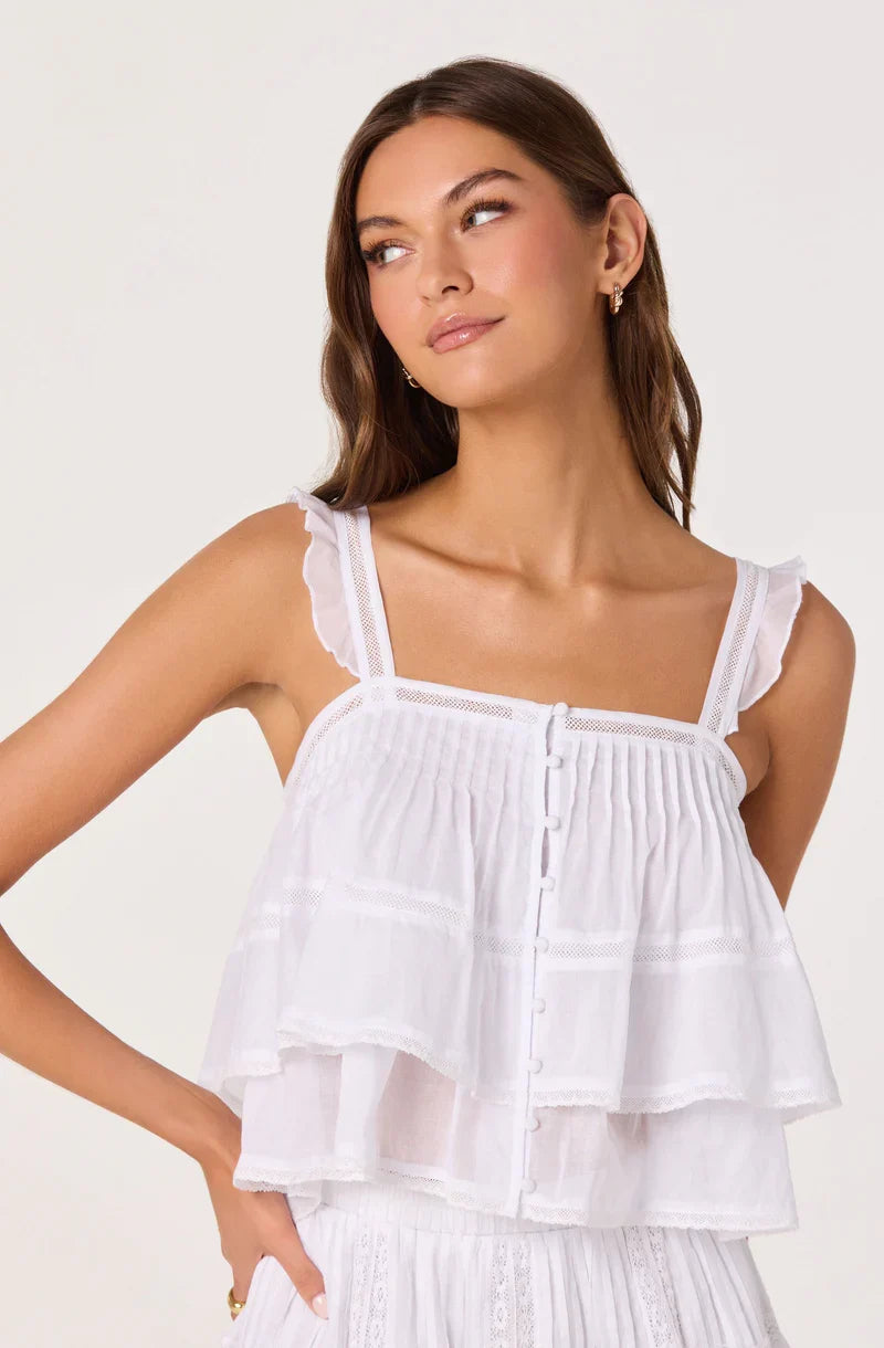 White tiered babydoll top with square neckline, ruffled tiers, and thin spaghetti straps