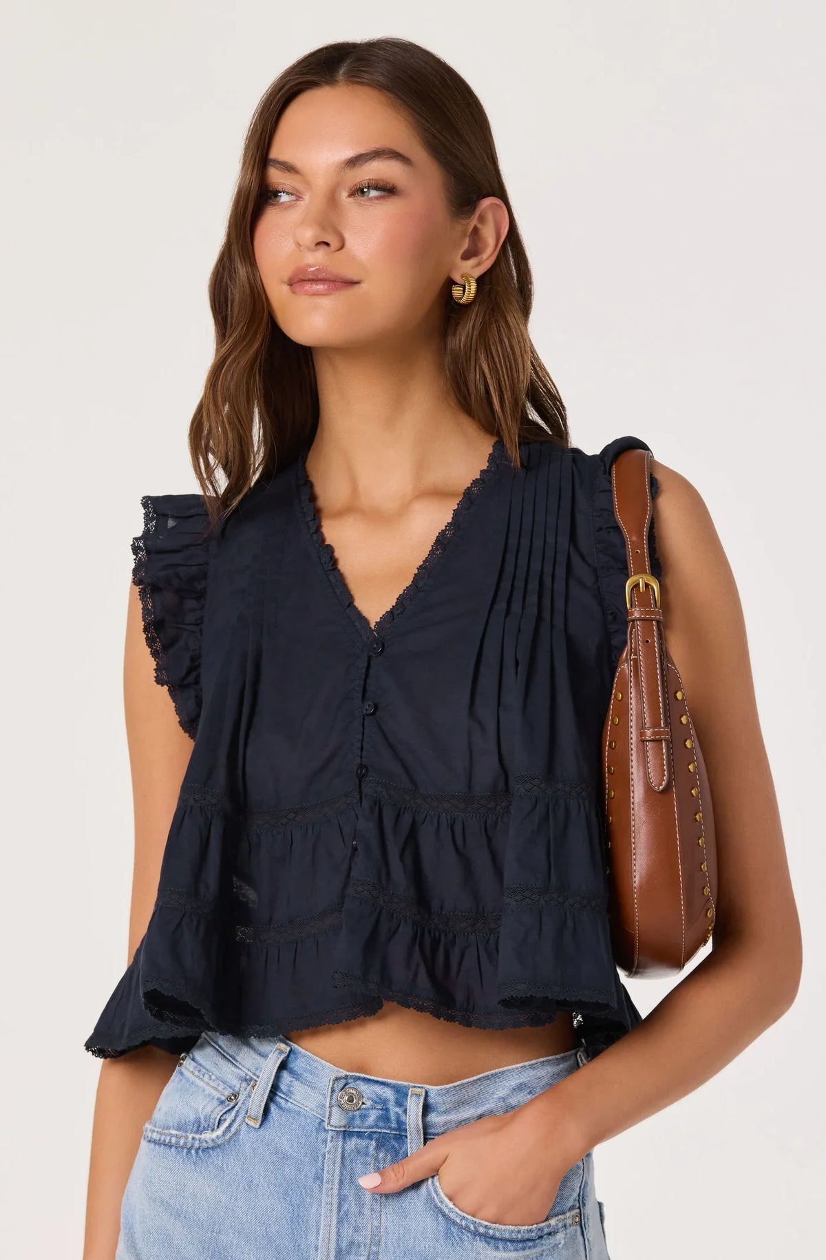Navy V-neck ruffle sleeveless top with button front and tiered hem