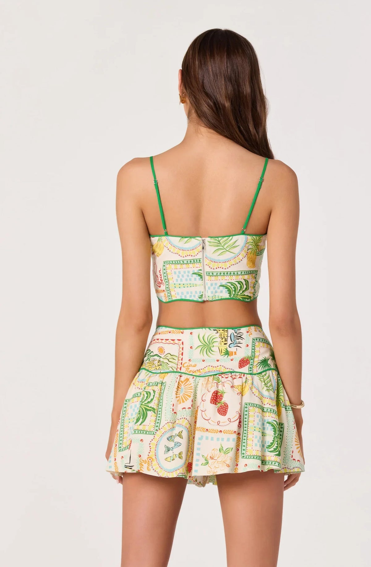 Back view farm print cropped camisole top with green spaghetti straps