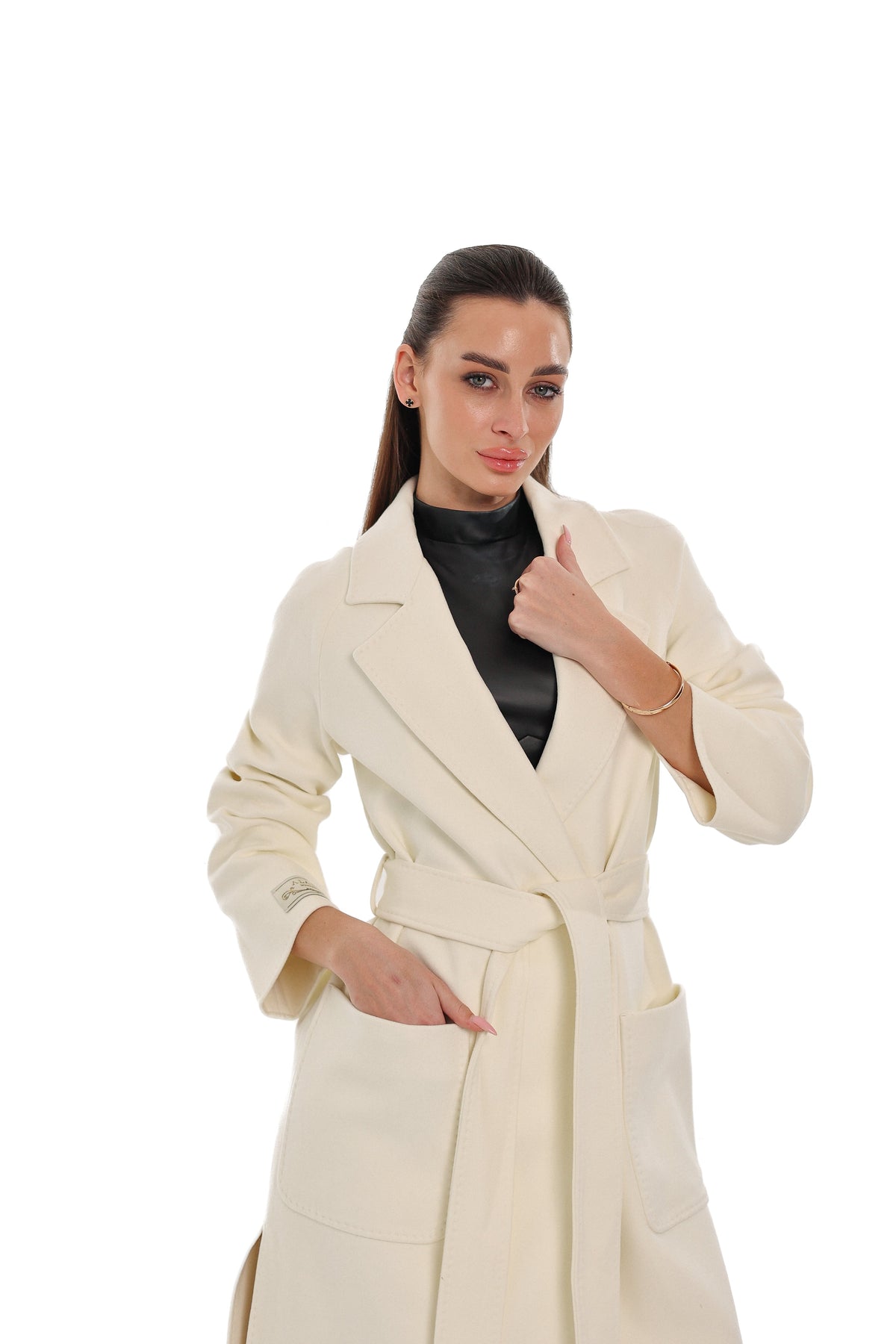 Ivory belted overcoat with wide lapels and large front patch pockets