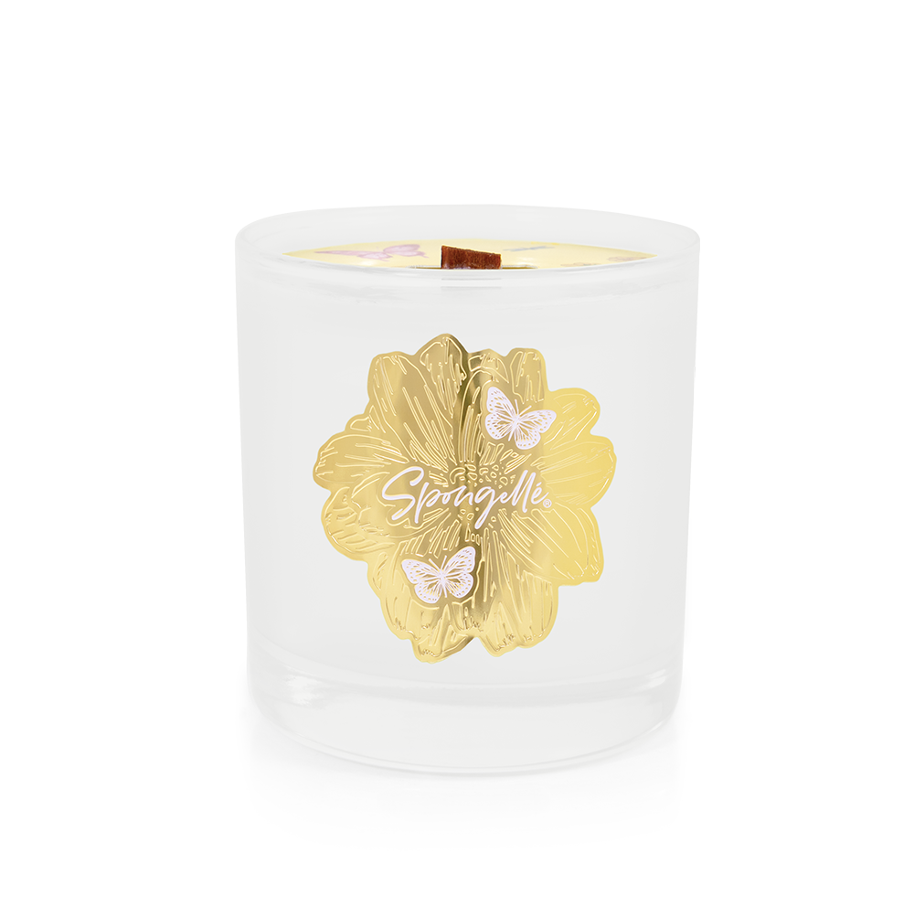 White Petitgrain Botanica candle with gold floral logo and visible wick