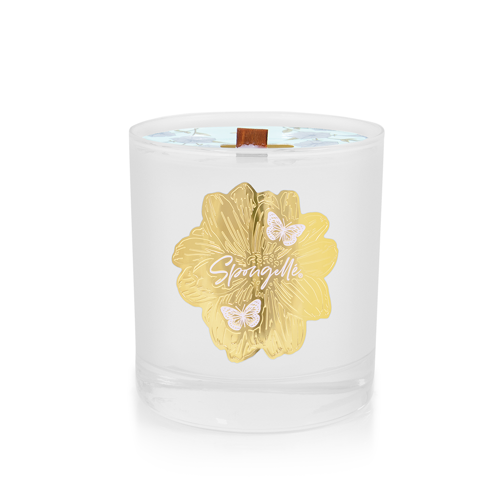Botanica candle in clear glass jar with gold floral label and wooden wick