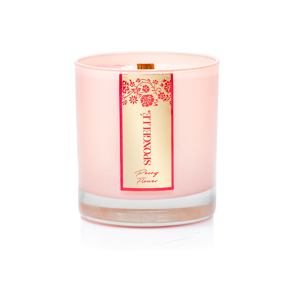 Pink scented candle in clear glass with gold wick and floral label