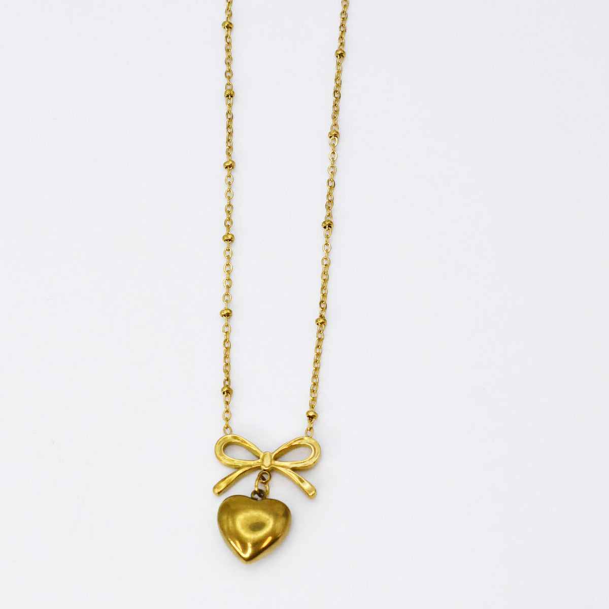 Gold bow and heart pendant necklace on a fine chain