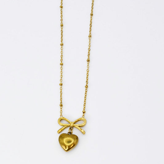 Gold bow and heart pendant necklace on a fine chain