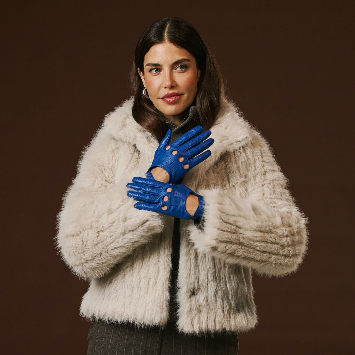 Blue Italian lambskin leather driving gloves with perforations, on a model