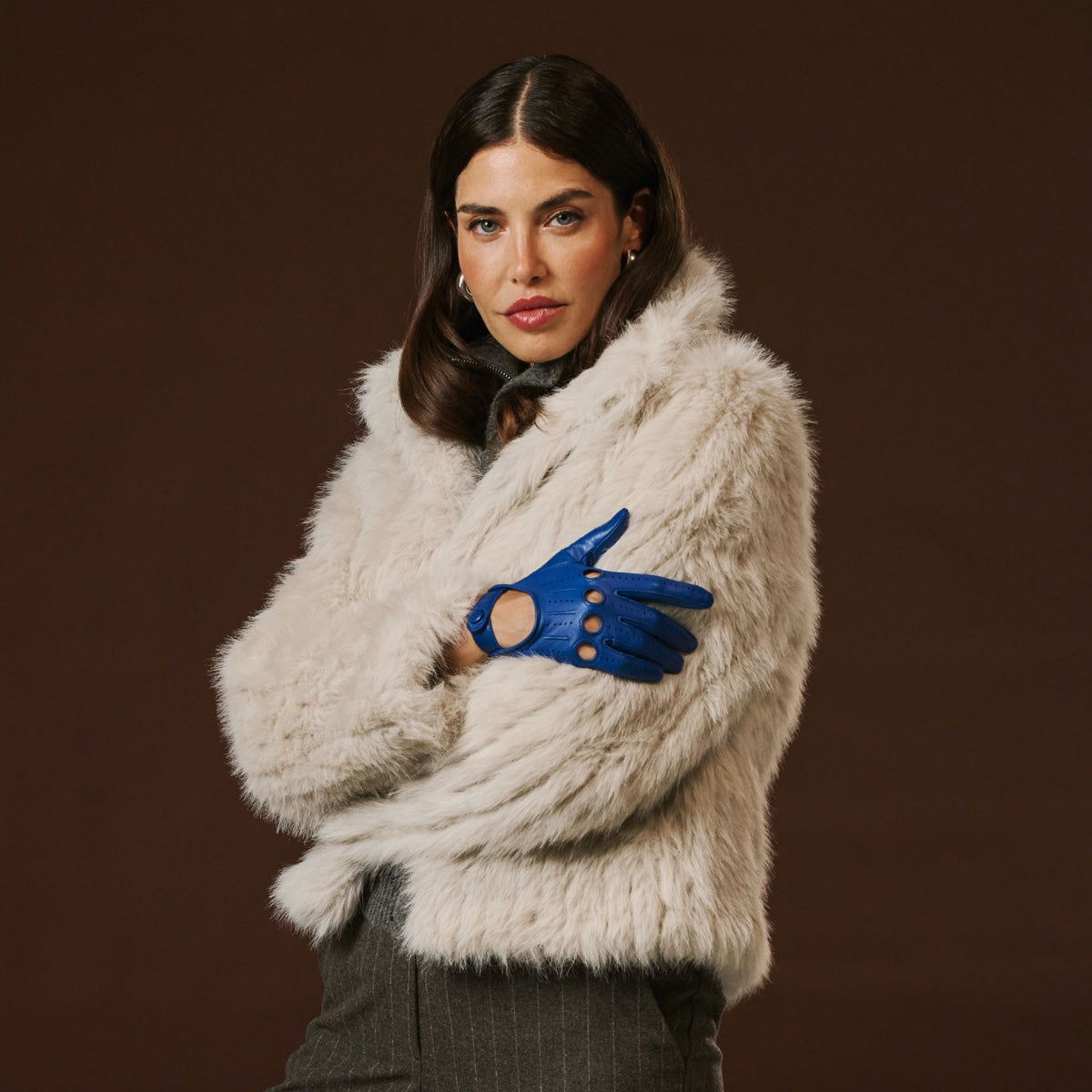 Blue Italian lambskin leather driving gloves on a model, glove design in view
