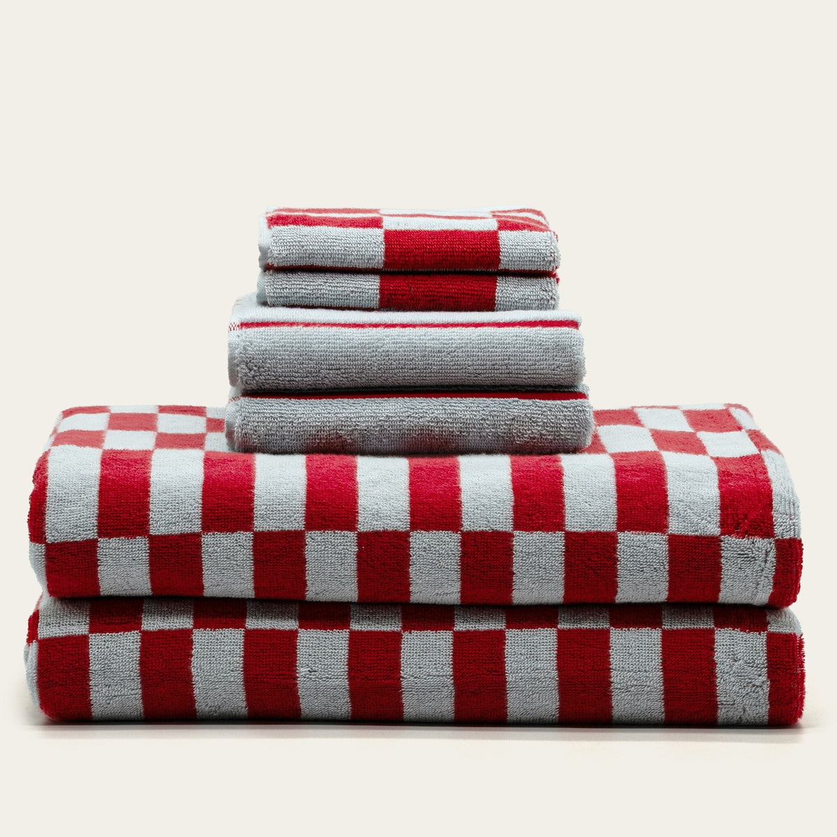 Stack of folded red and white checkered cotton towels