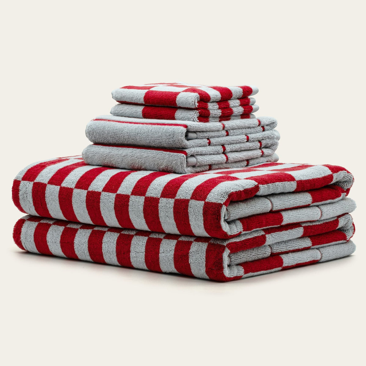 Stacked folded red and white checkered cotton towels