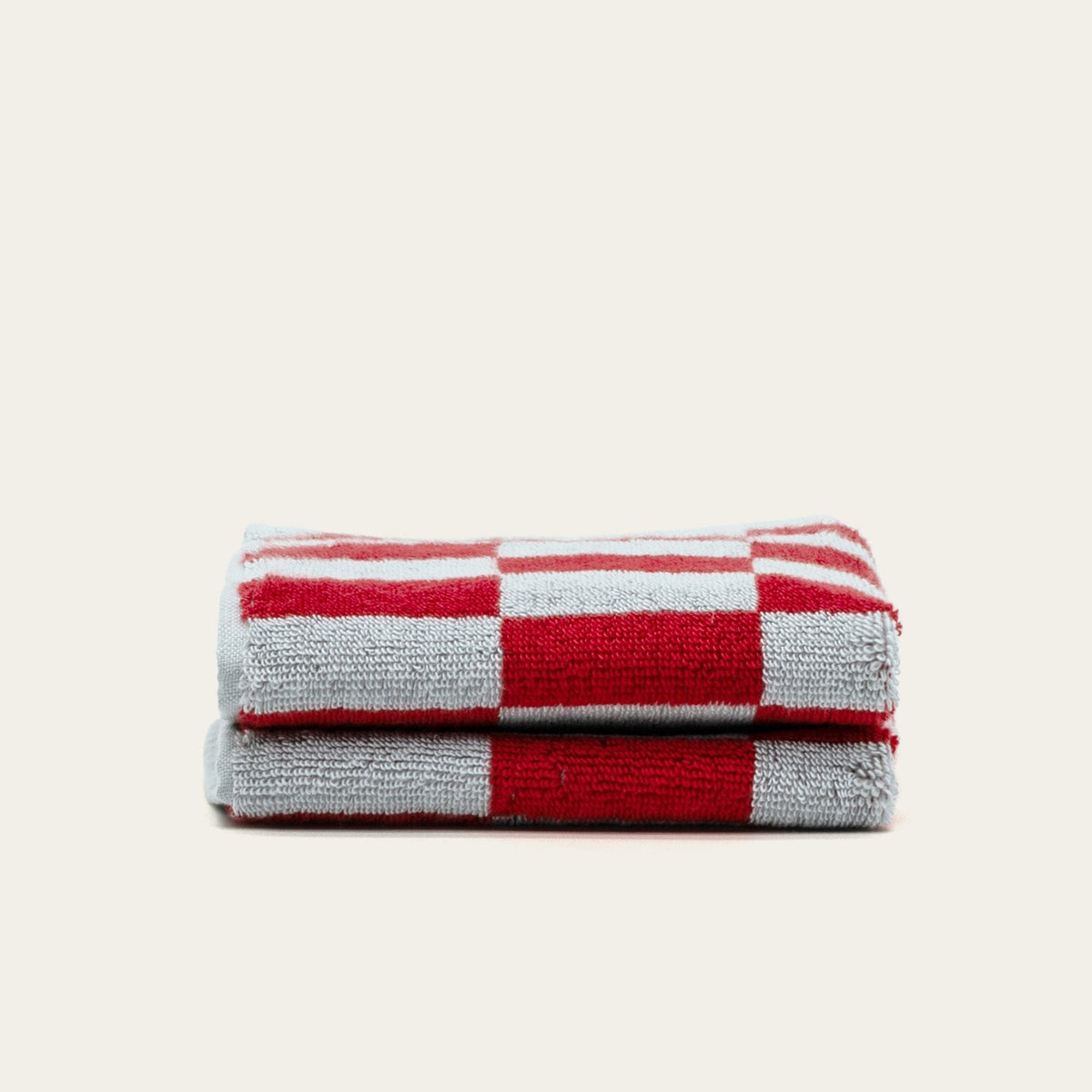 Australian cotton towel in red and white check pattern, folded for display