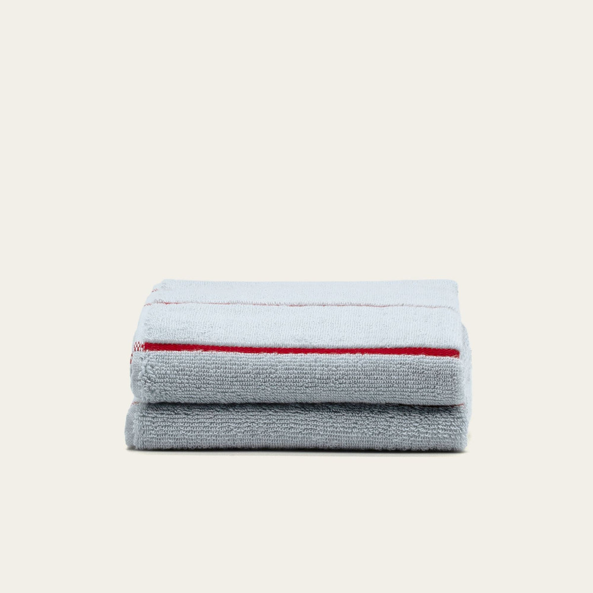 Light gray cotton towel stack with red stripe border