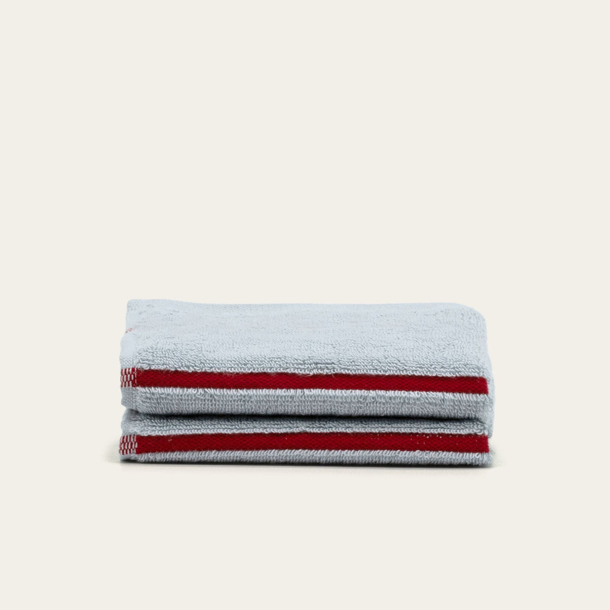 Three light gray cotton towels with red stripe accents