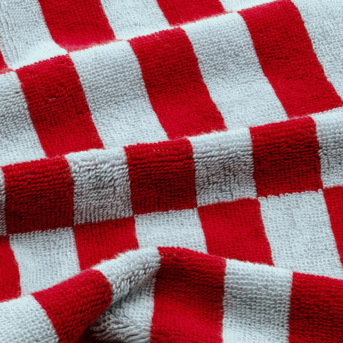 Close-up red and white buffalo-check cotton towel fabric texture