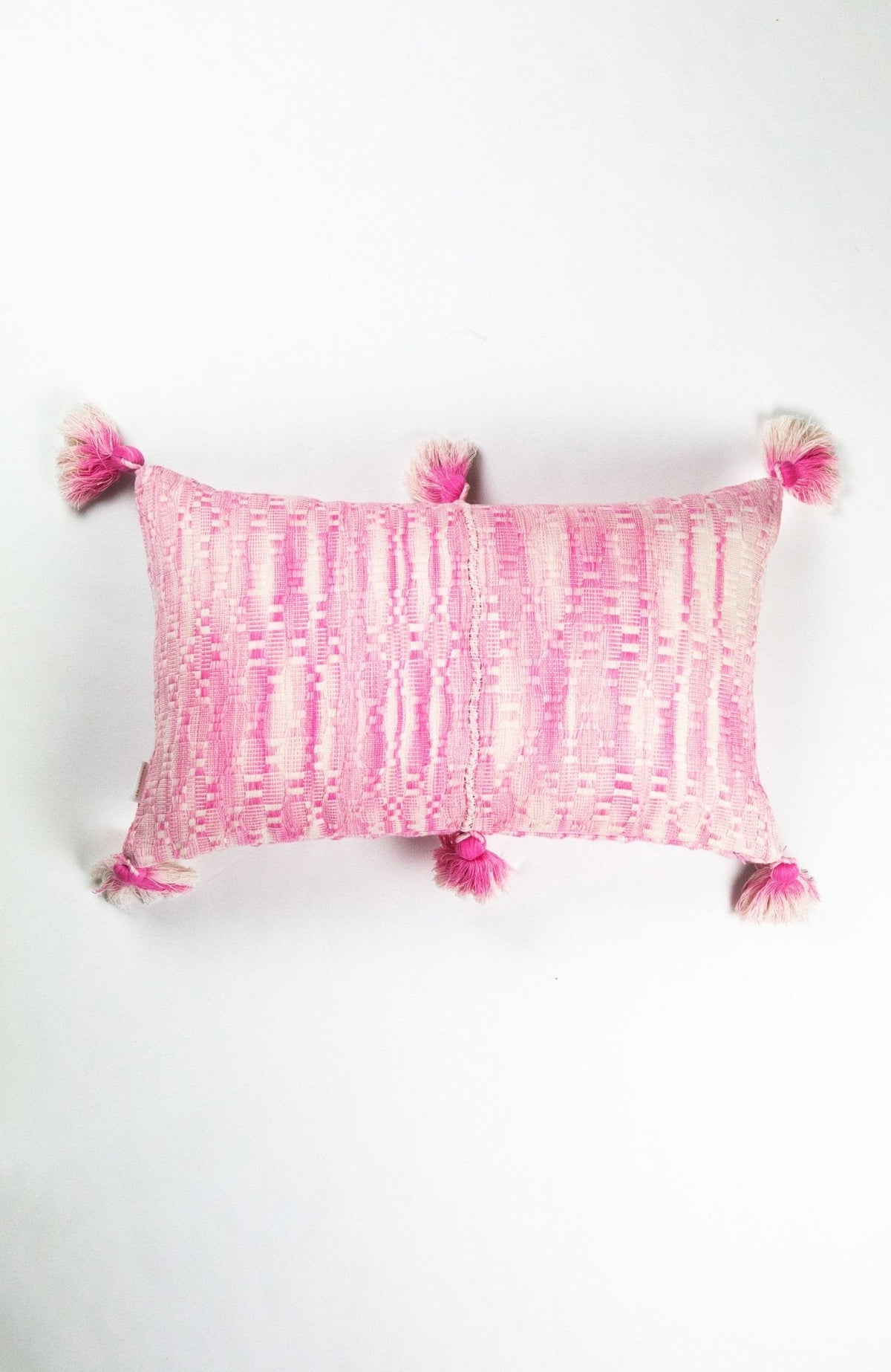 Faded pink striped rectangle pillow with tasseled pom-pom corners