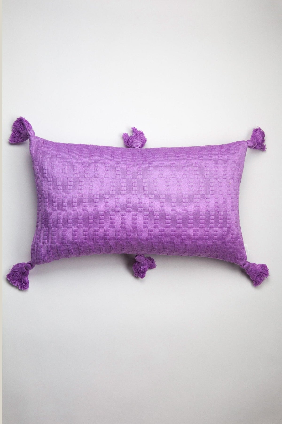Orchid solid pillow cover with corner tassels and textured fabric