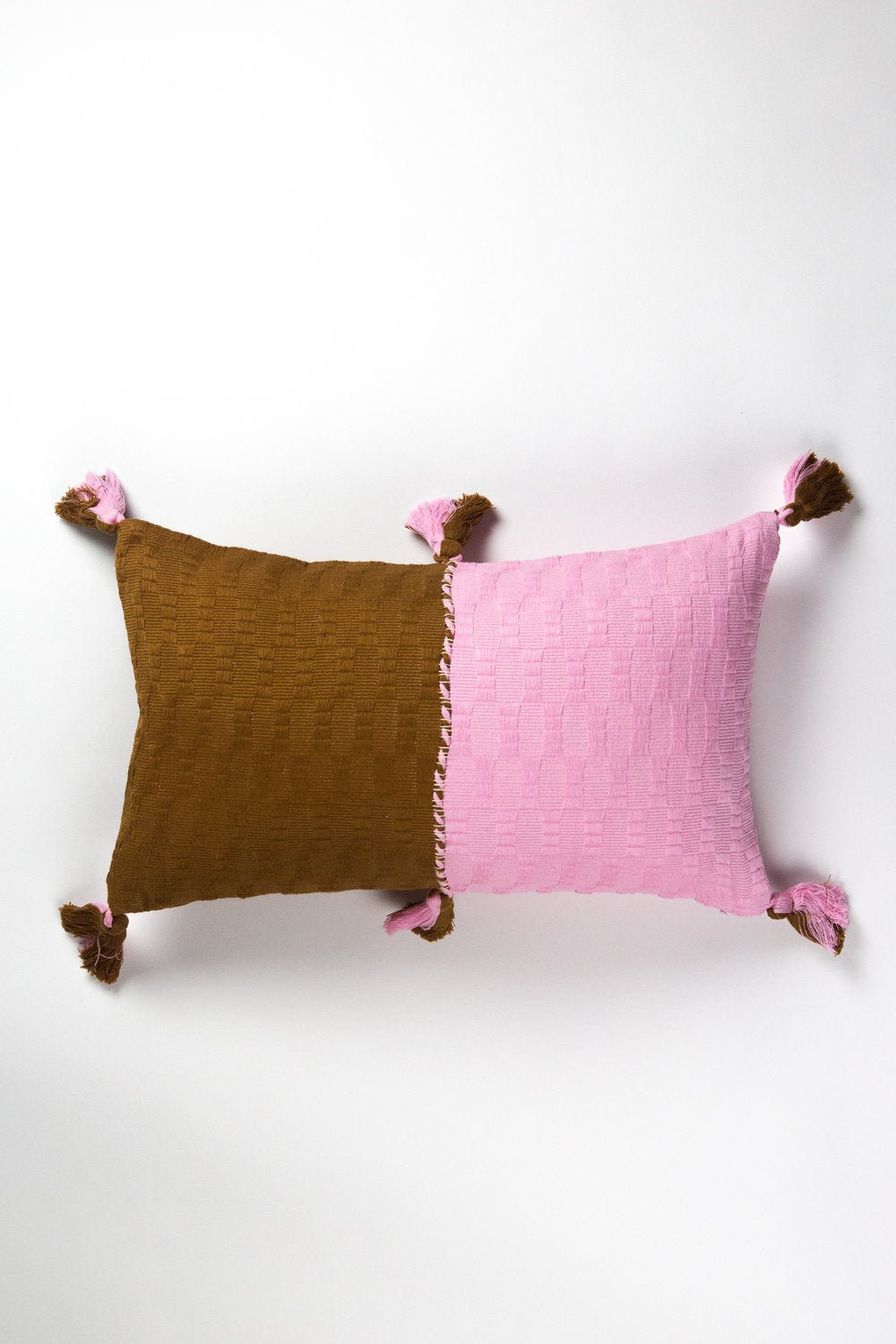 Colorblocked throw pillow set in baby pink and umber with tassel corners