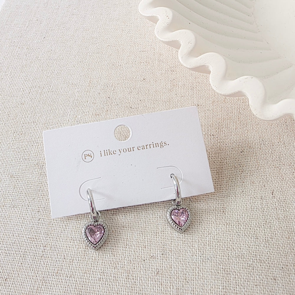 Silver-tone heart dangle earrings pair with pink heart charms on card
