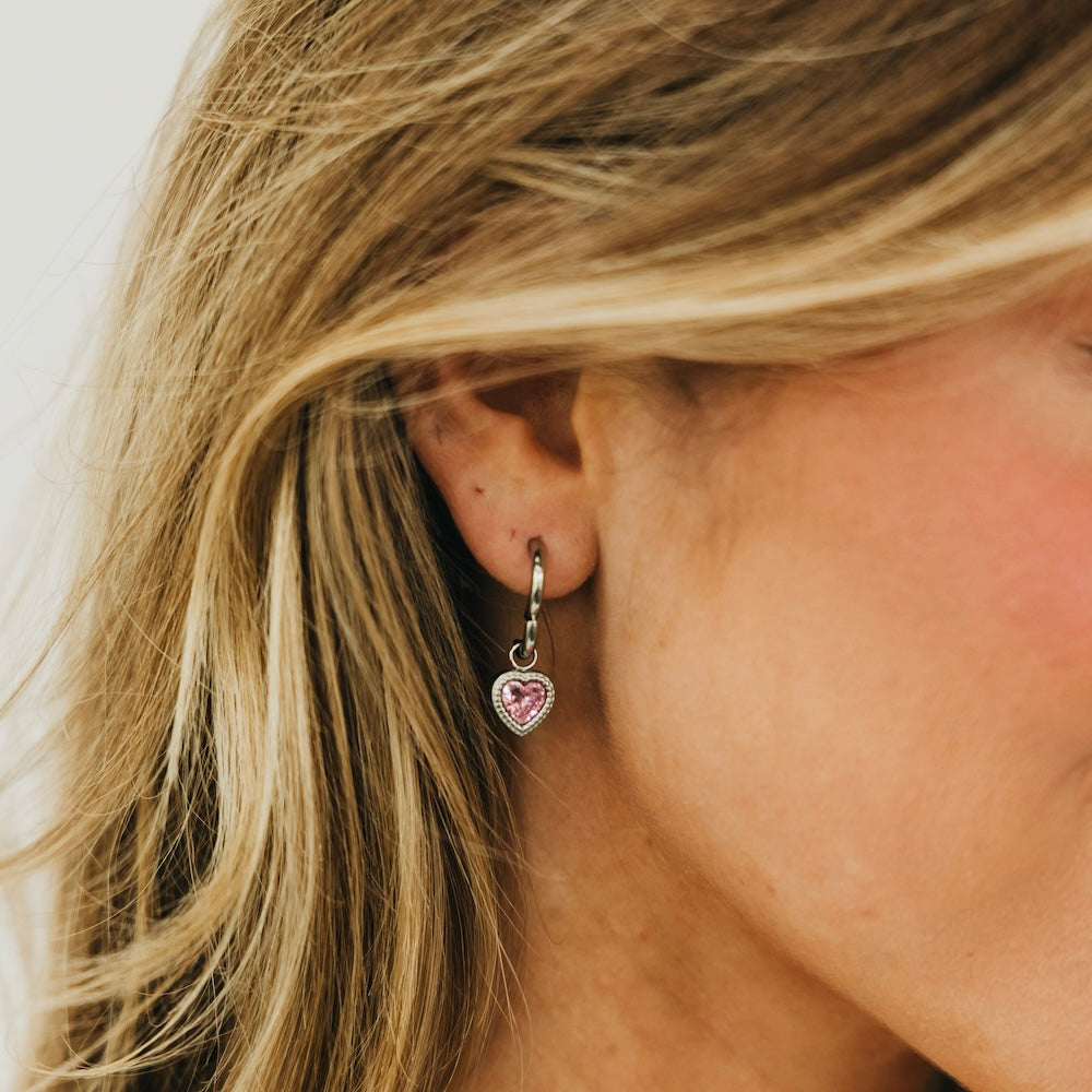 Gold-tone heart dangle earrings with pink heart charm and hanging hook