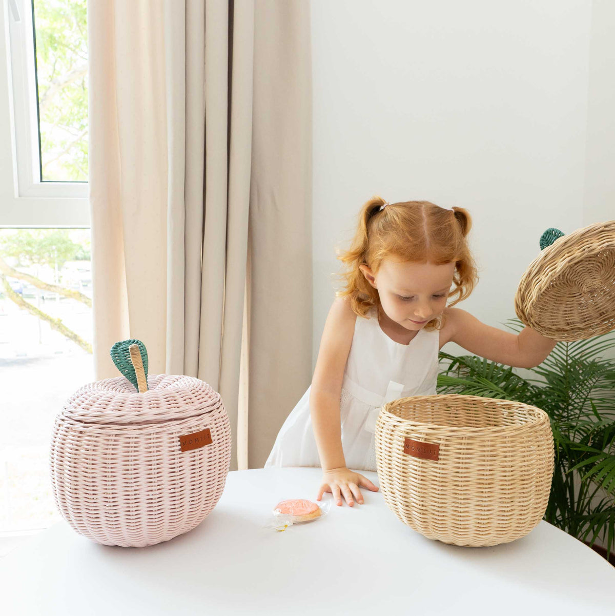 Natural rattan apple basket shown open beside its woven lid