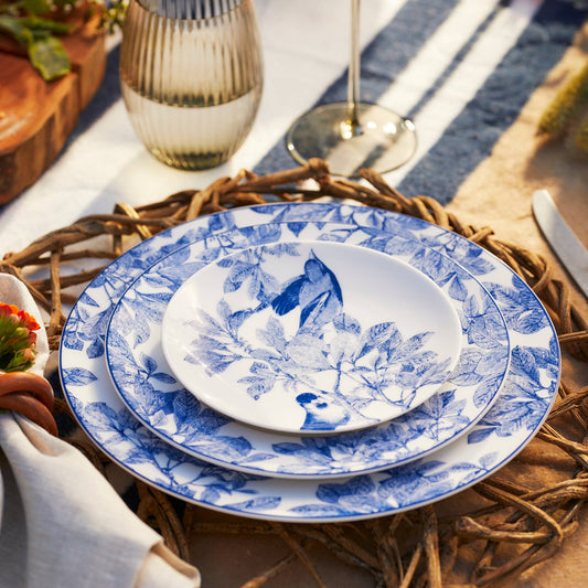 Round porcelain plate with layered blue botanical pattern rim and white center