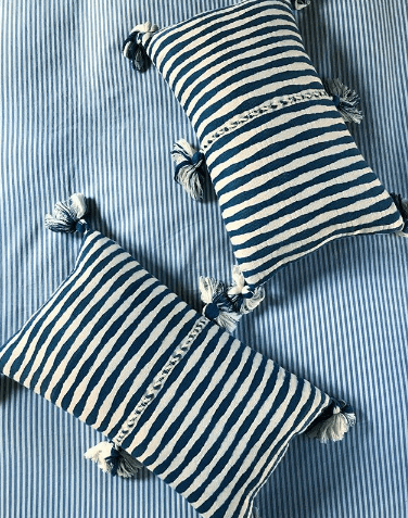 Set of striped throw pillows in navy-blue and white with tassel corners