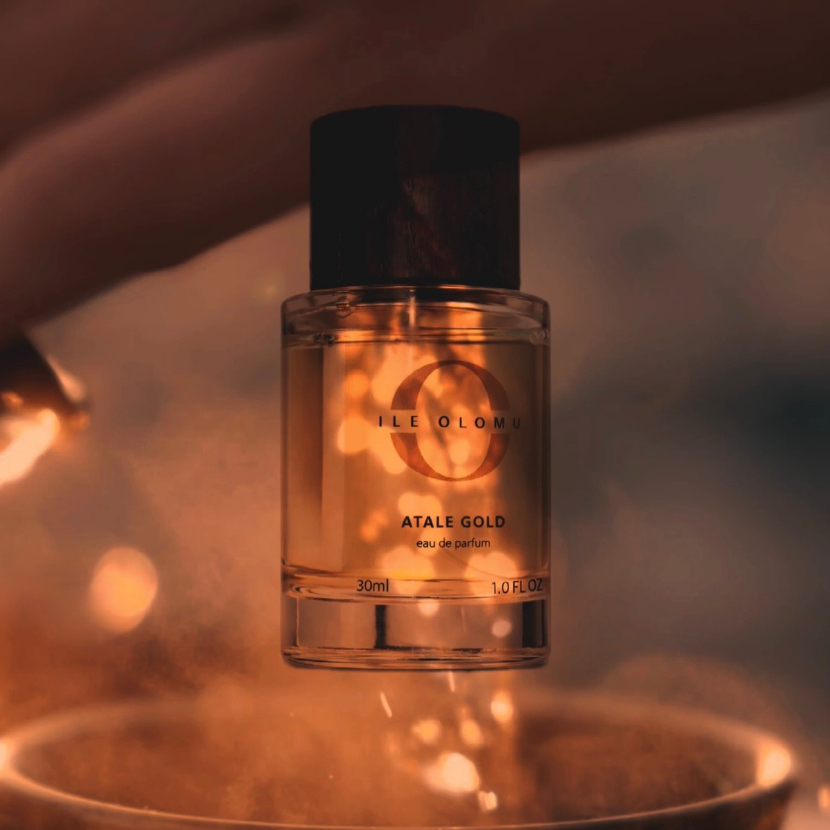 Eau de parfum bottle with dark wood cap, gold-toned liquid, 30 ml