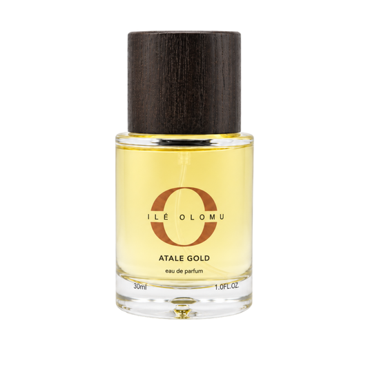 Atalẹ Gold eau de parfum bottle with dark wood cap and gold liquid