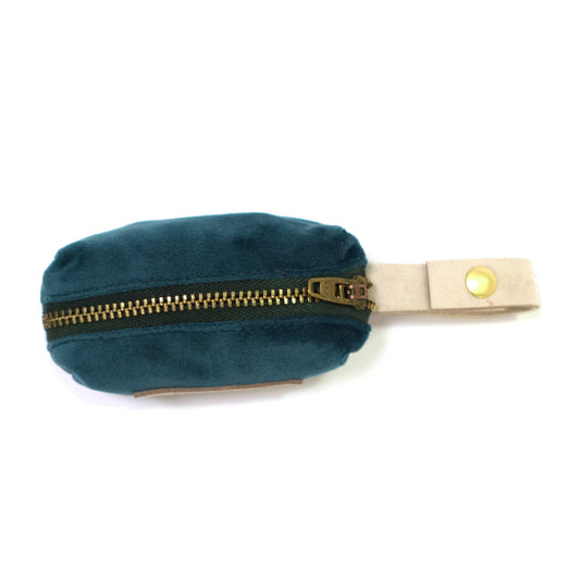Teal velvet waste bag holder with gold zipper, beige clip strap, and loop