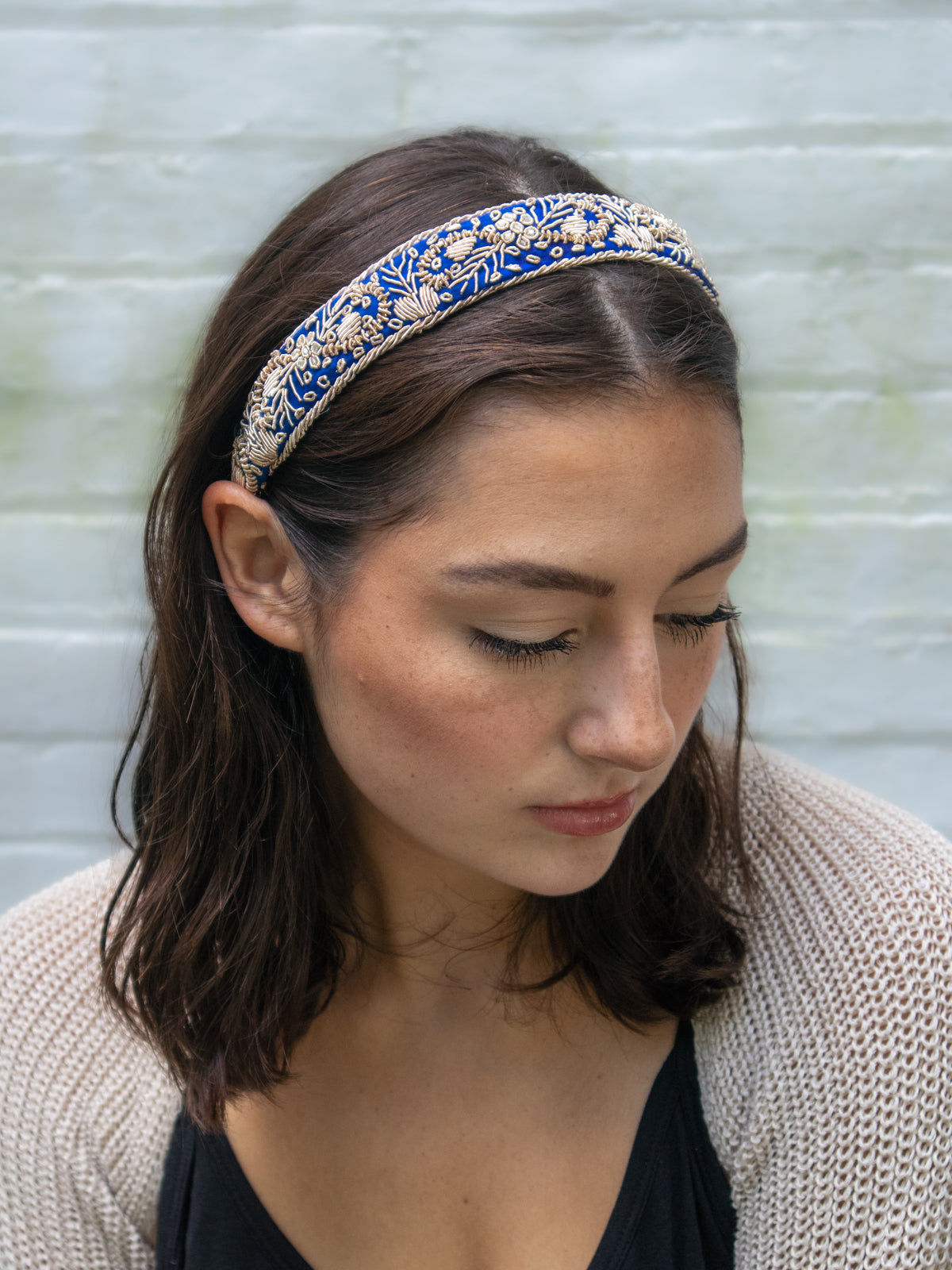 Aurelia Filigree Headband in blue with ornate gold embroidery, worn in dark hair