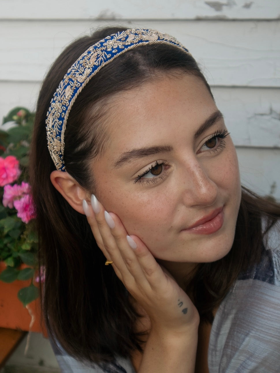 Blue and gold embroidered Aurelia Filigree Headband worn across the hair