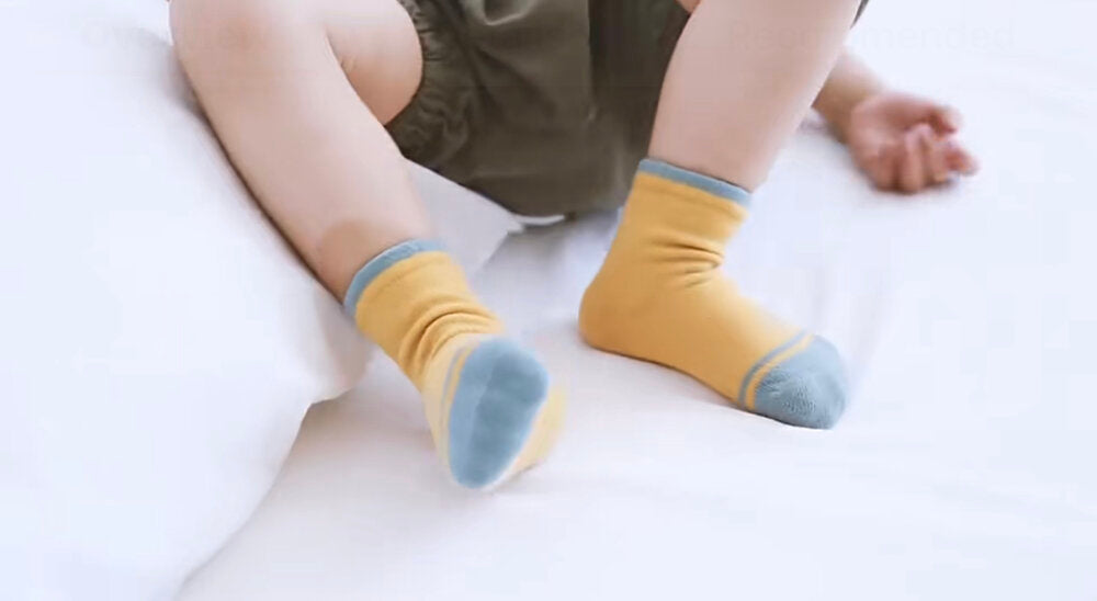 Kids organic cotton socks on toddler feet: mustard yellow with light blue trim