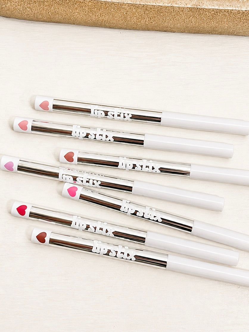 Set of lip liner pencils with white bodies and colored tips, hearts at the ends.