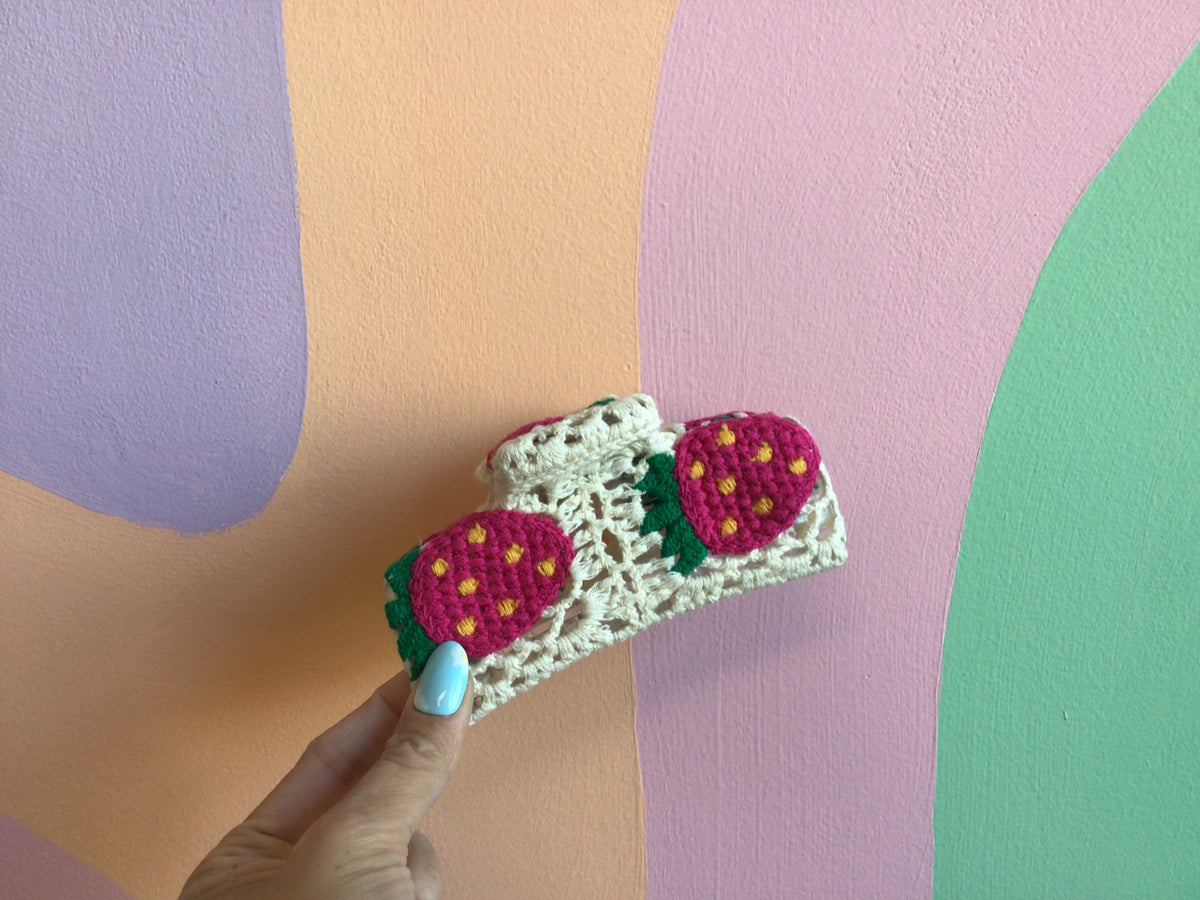 Crocheted hair claw with pink strawberry motifs