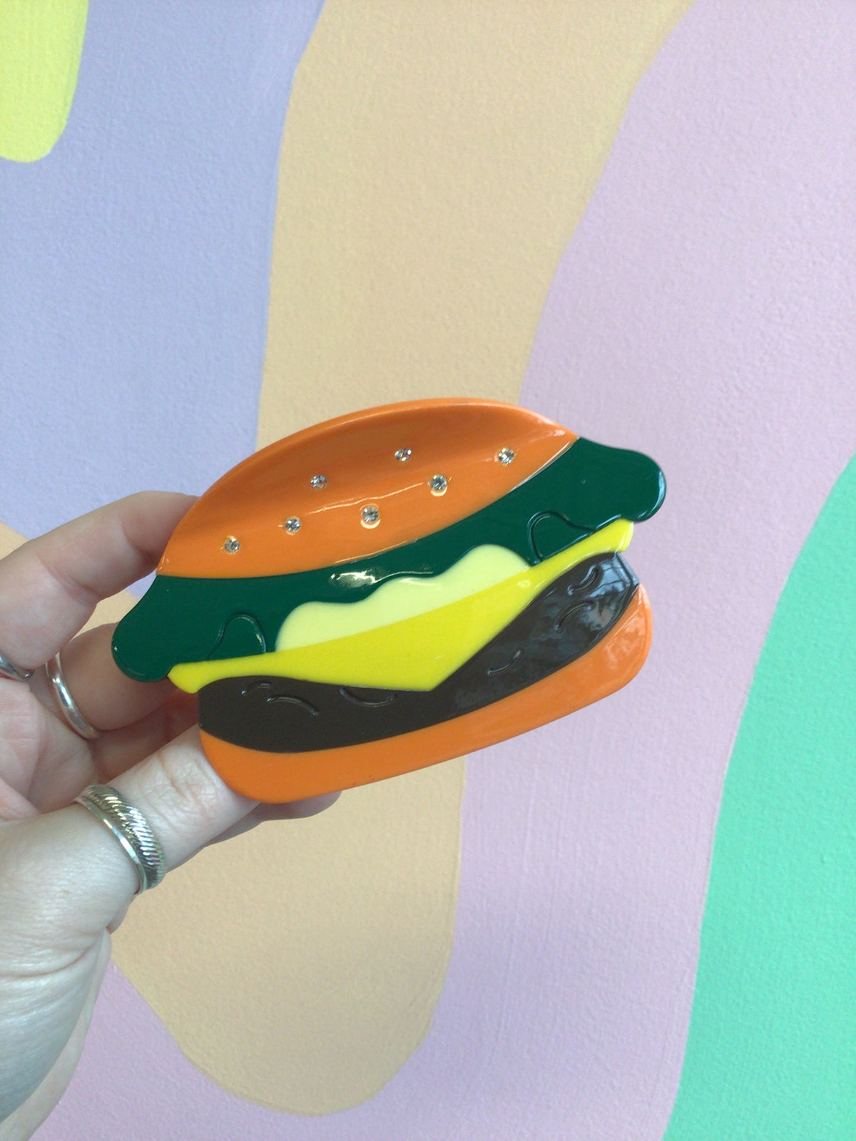 Cheeseburger-shaped hair claw with green, yellow, and orange layers