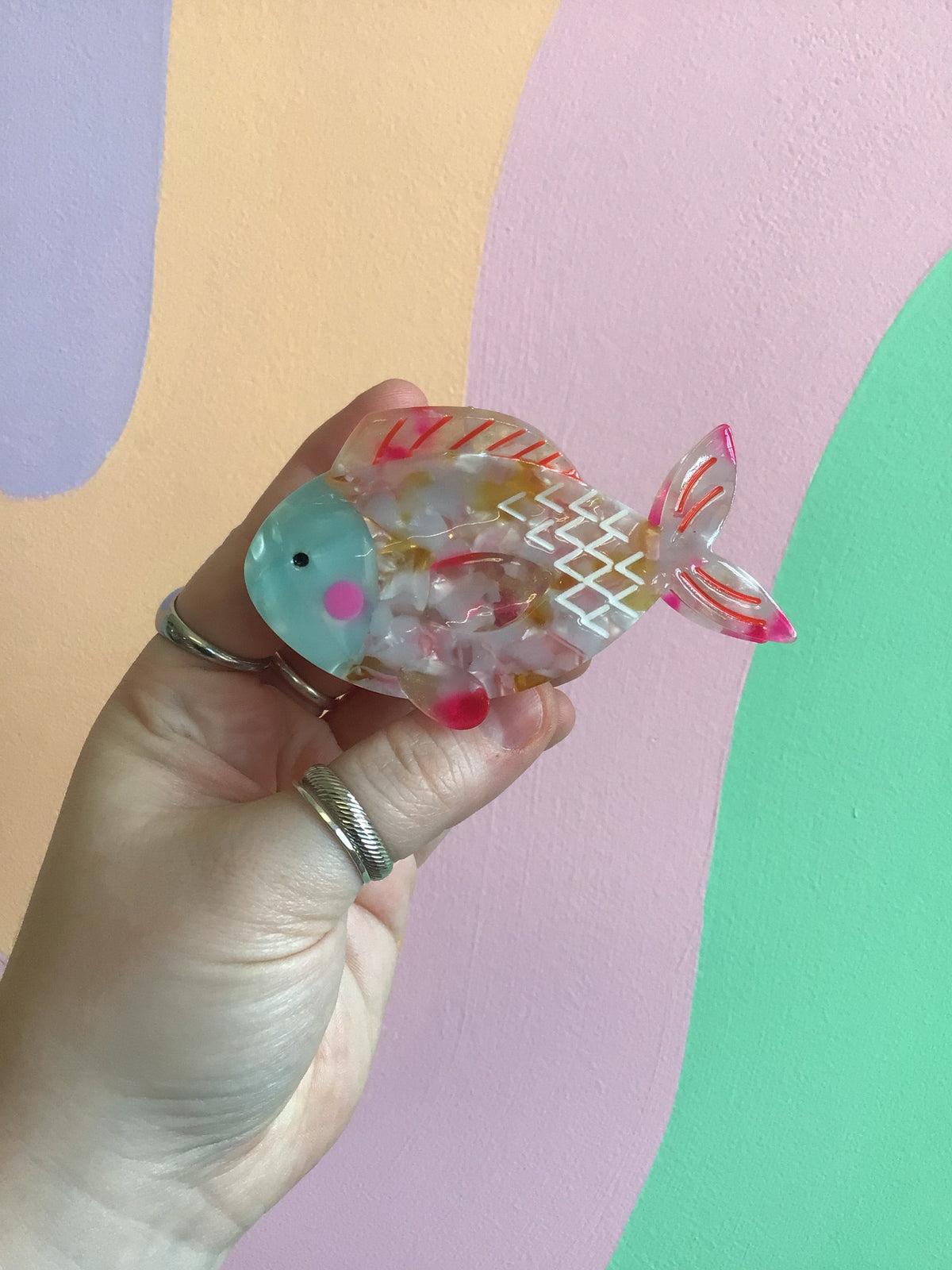 Ocean-themed hair claw shaped like a translucent teal fish with pink tail