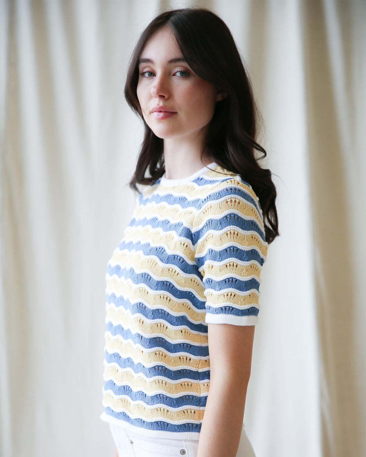 Striped knit sweater in blue and yellow wavy stripes, crew neck, short sleeves