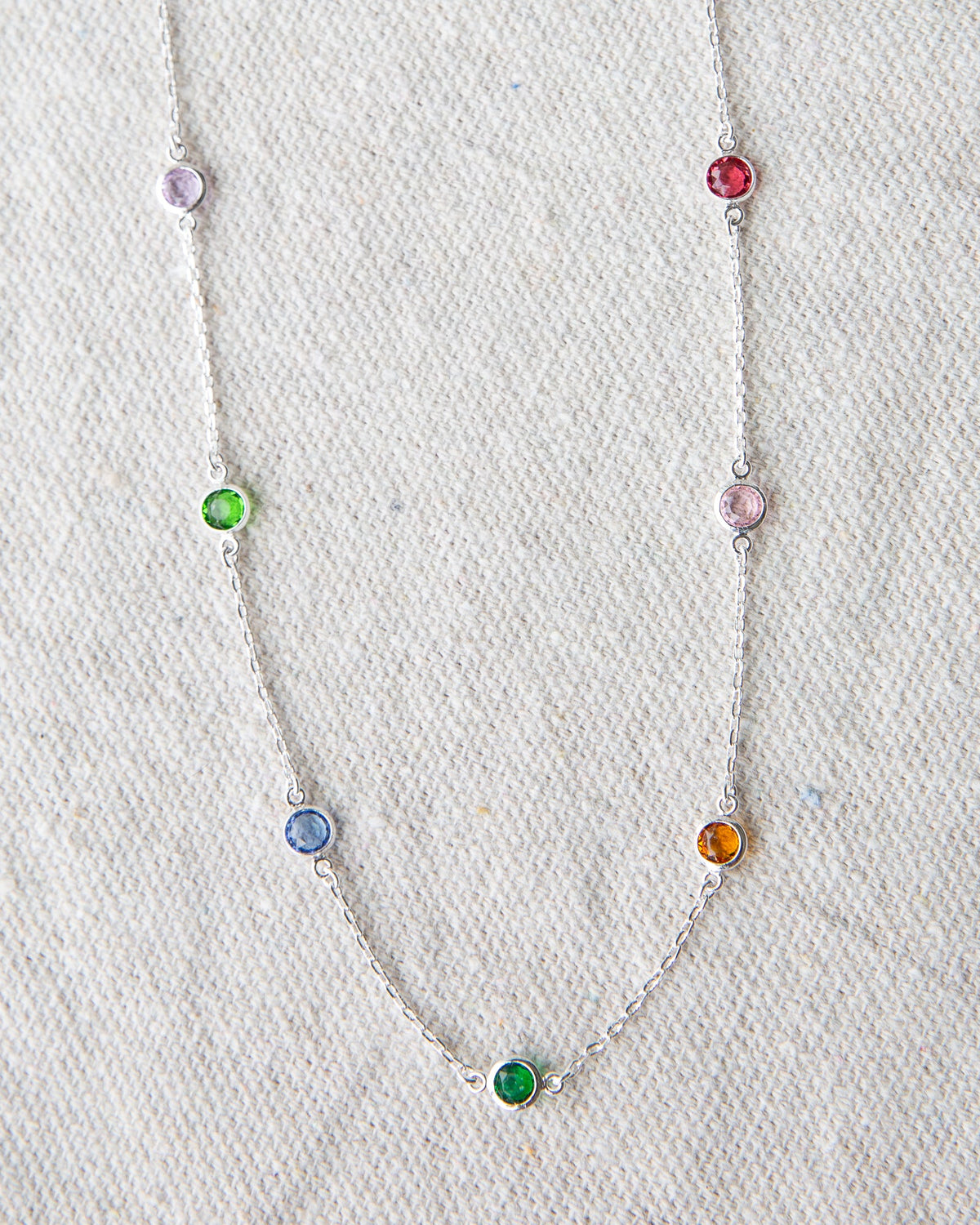 Silver-tone chain necklace with multicolor round gemstone beads, close-up front