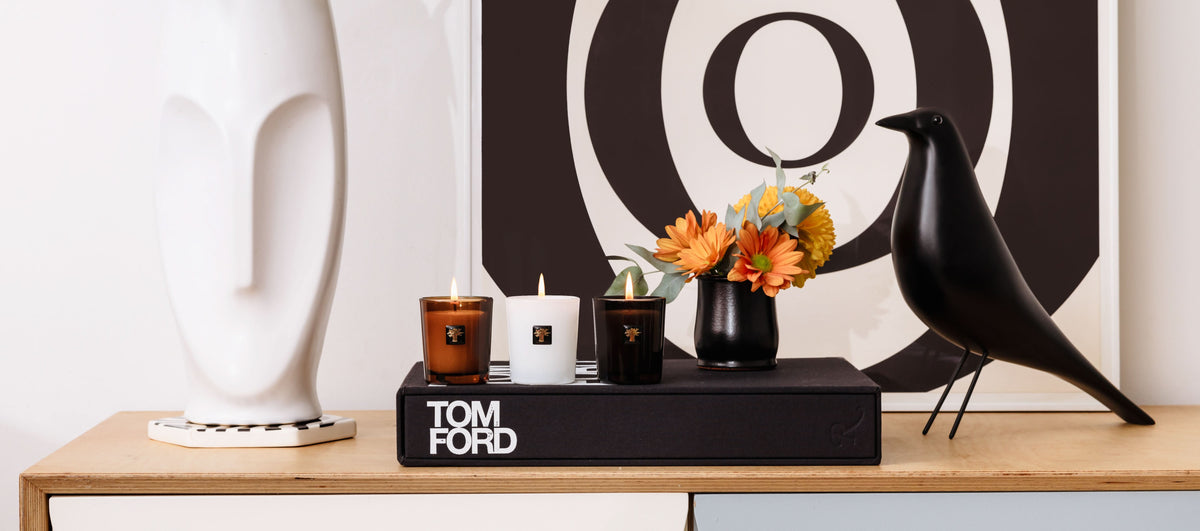 Trio travel candle set with three lit candles on a black display tray