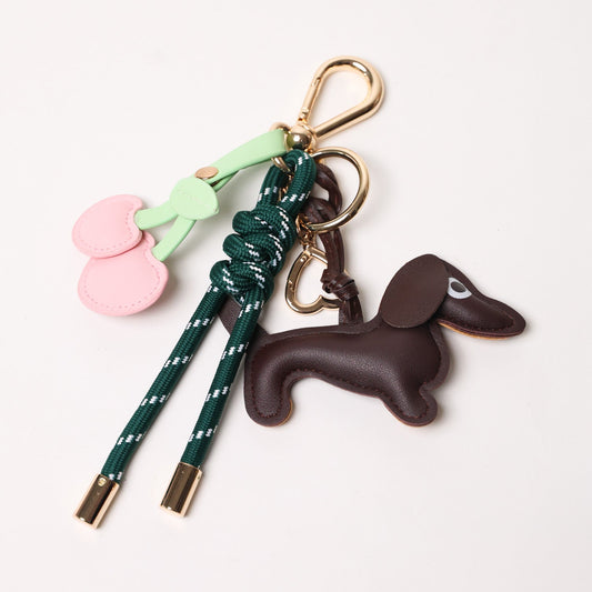 Emerald green key chain with brown dog charm and pink heart cherry charms