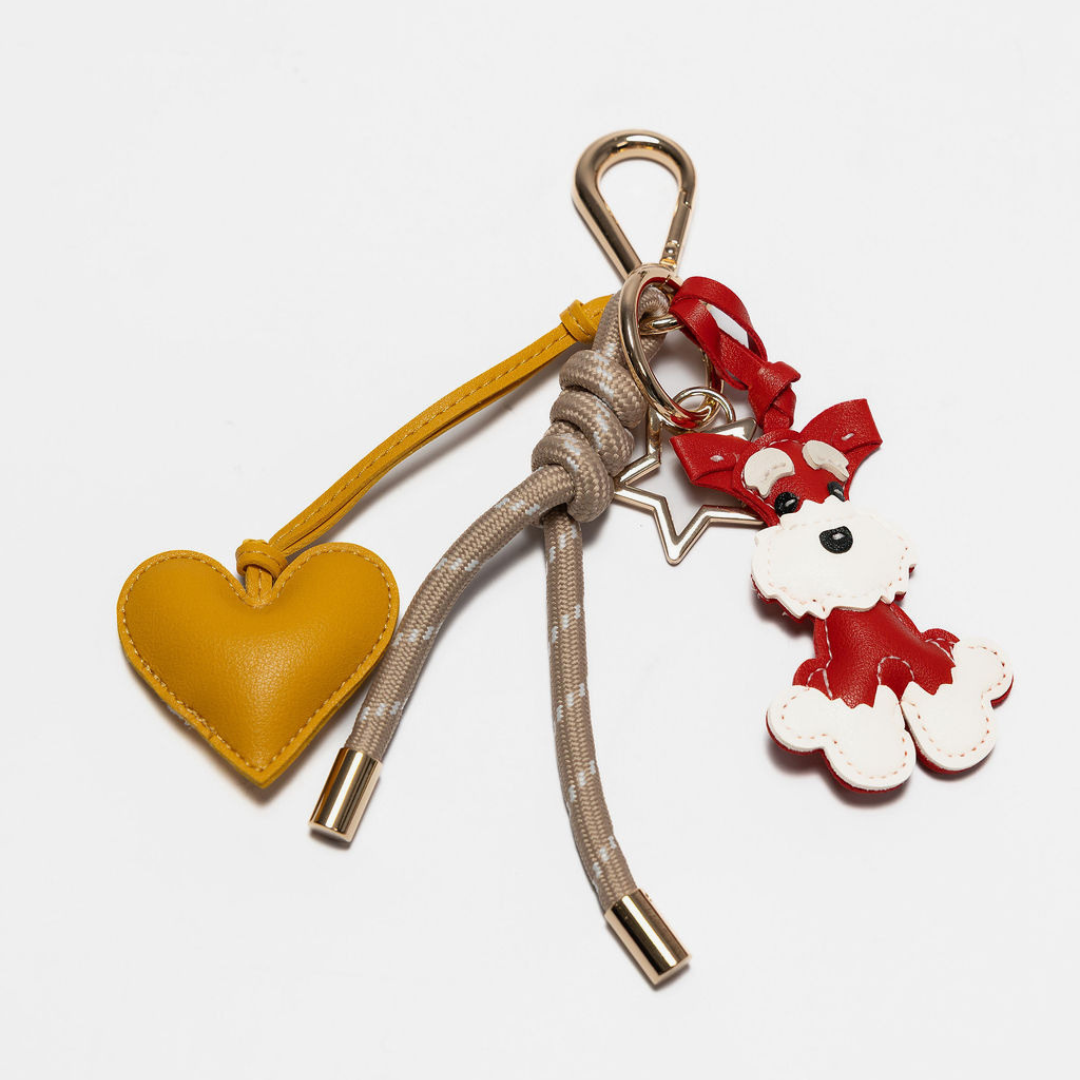 Taupe keychain with yellow heart charm and red schnauzer charm, metal clips.