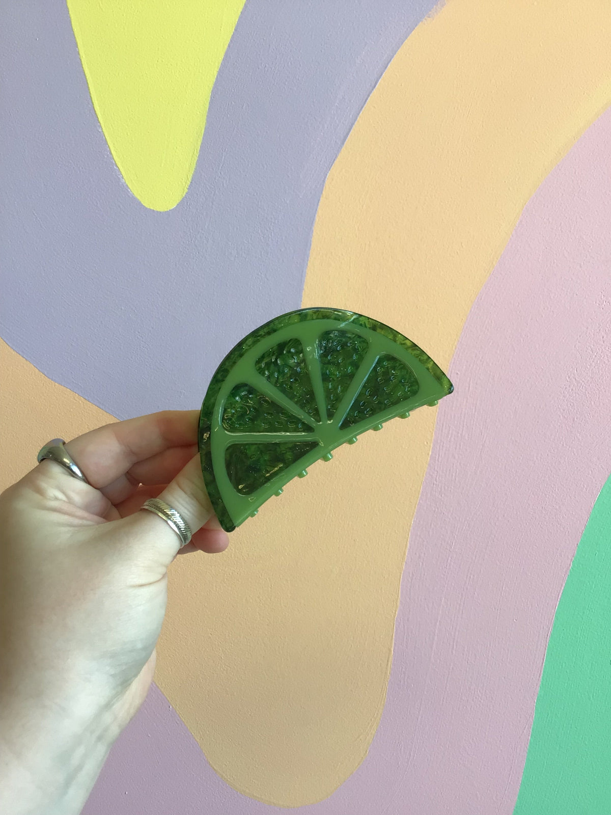 Green citrus-shaped hair claw clip with segmented leaf-like design