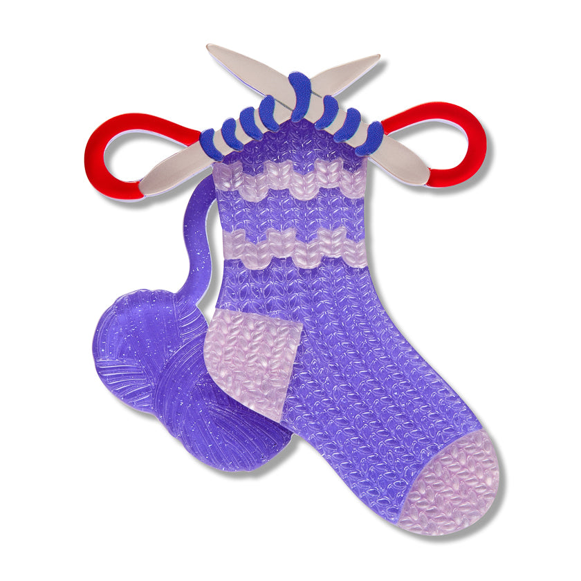 Purple glitter-style sock brooch with red hanger loops and dangling tails
