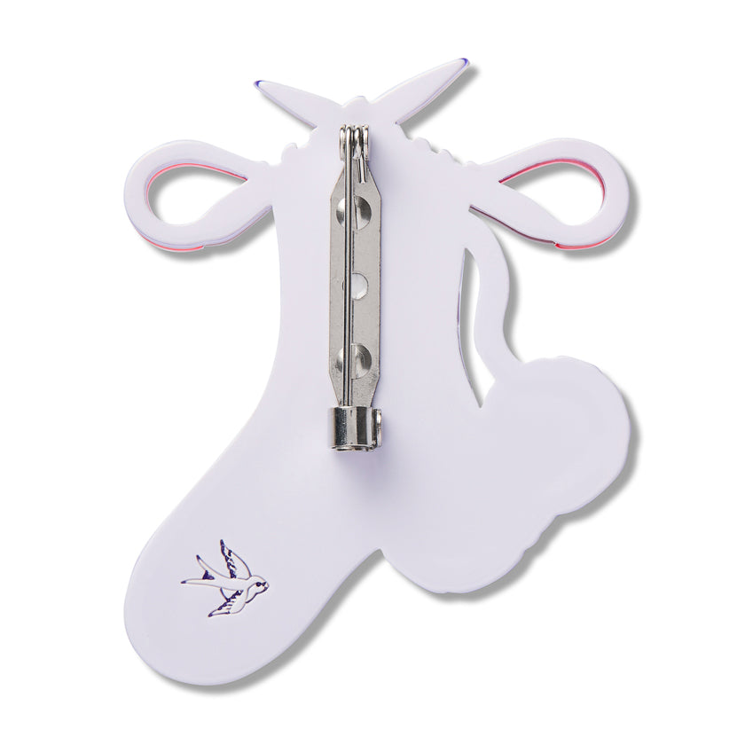 White sock-shaped brooch backing with silver safety pin and loop details