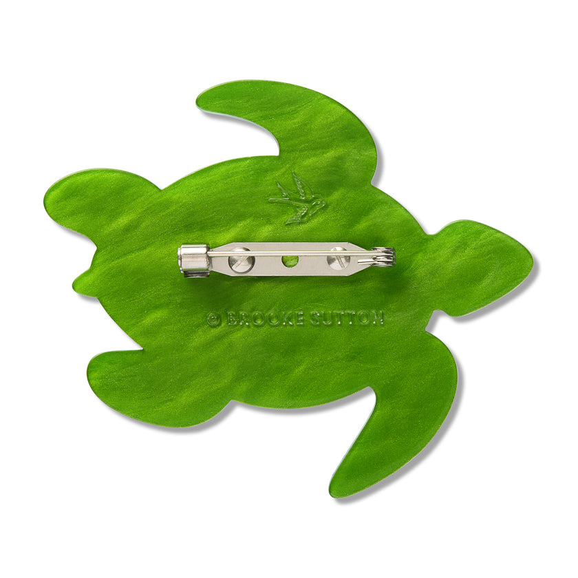 Green turtle brooch back with metal pin and clasp at the center