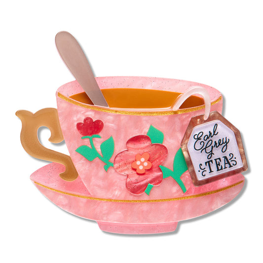 Pink enamel teacup brooch with flowers, spoon, and Eat Grey Tea label