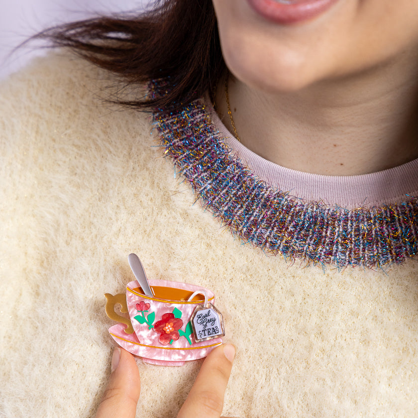 Teacup enamel brooch worn on clothing, pink cup with tea label and red flower